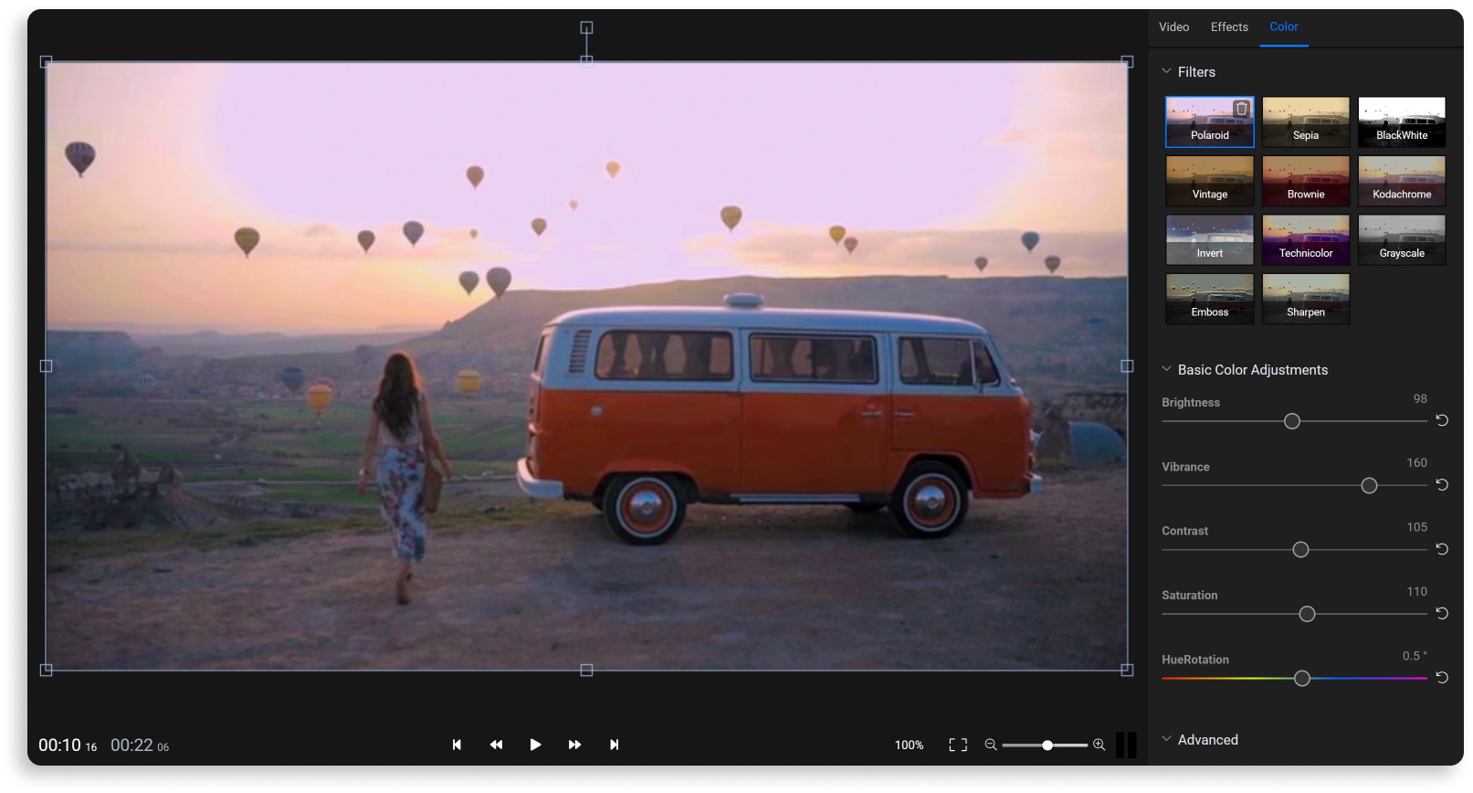 A shot of a woman walking toa vintage van, with hot air balloons in the background. The footage is being color graded using  the Flixier color adjustment tab.